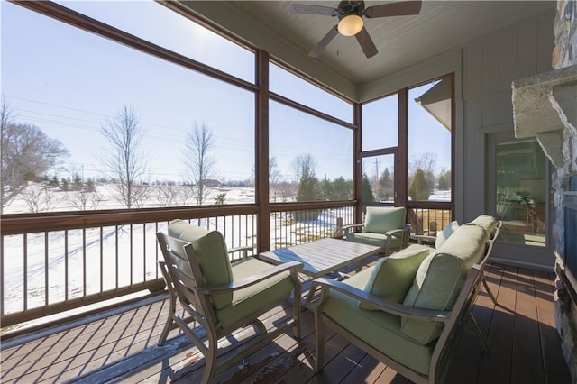 sunroom / solarium featuring ceiling fan