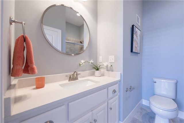 bathroom featuring toilet, visible vents, vanity, baseboards, and marble finish floor