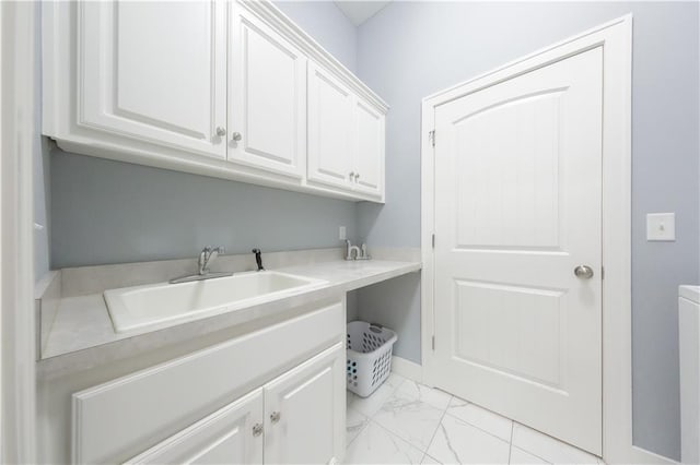 washroom featuring marble finish floor and a sink