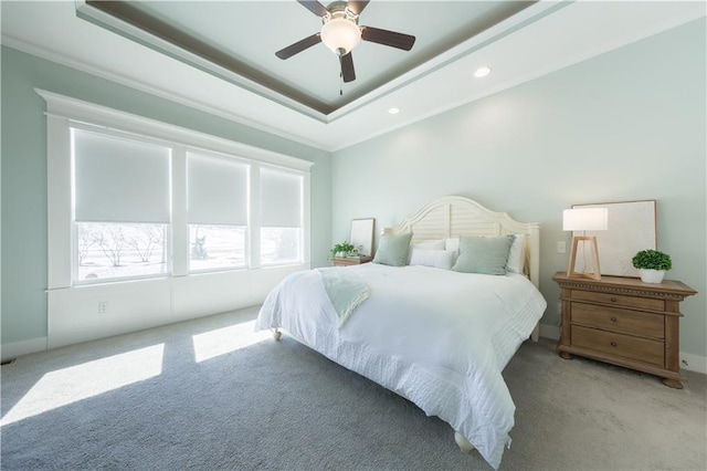 bedroom featuring carpet floors, a tray ceiling, crown molding, recessed lighting, and a ceiling fan