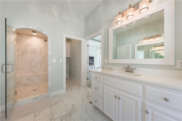 full bathroom with marble finish floor, baseboards, vanity, and a marble finish shower