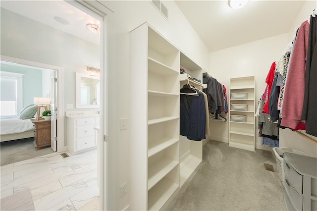 walk in closet featuring marble finish floor and visible vents