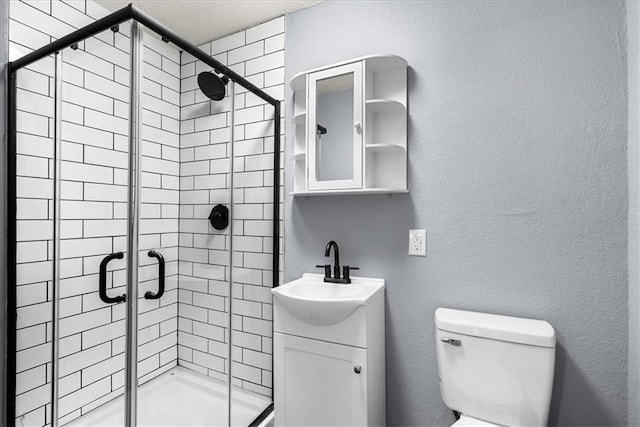 bathroom with an enclosed shower, vanity, and toilet