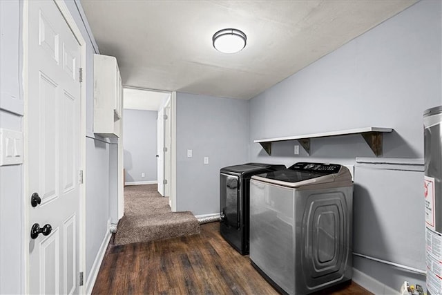 washroom with dark wood-type flooring and washer and clothes dryer