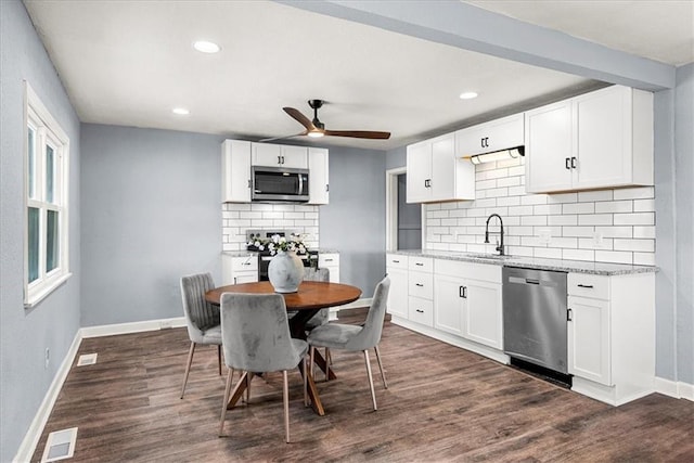 kitchen with white cabinetry, sink, stainless steel appliances, and dark hardwood / wood-style floors