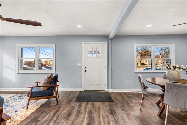 foyer featuring beam ceiling, dark hardwood / wood-style floors, and ceiling fan