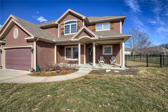 view of front of house with stucco siding, fence, a garage, driveway, and a front lawn