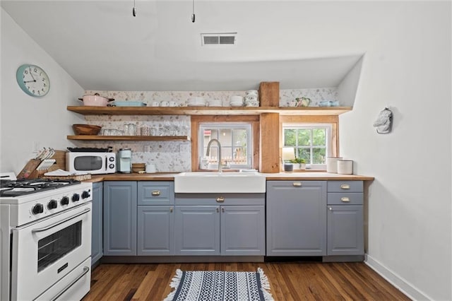 kitchen with white appliances, dark hardwood / wood-style floors, gray cabinets, and sink