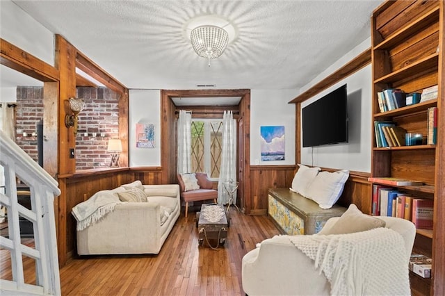 living room with light hardwood / wood-style flooring and a textured ceiling