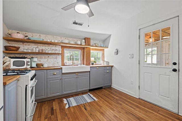 kitchen with gray cabinets, dishwasher, butcher block counters, and high end range