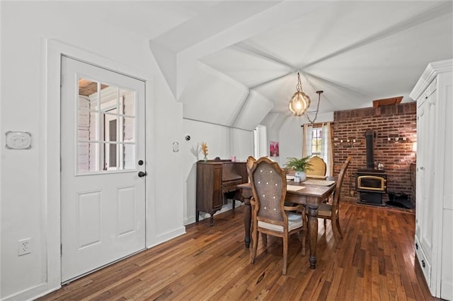 dining room featuring dark hardwood / wood-style floors and a wood stove