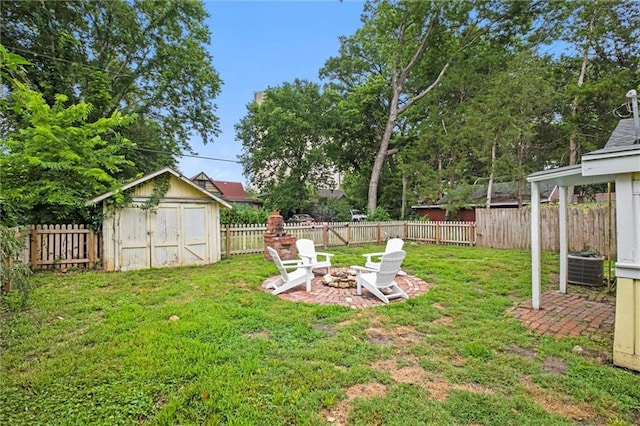 view of yard with a storage unit and a fire pit