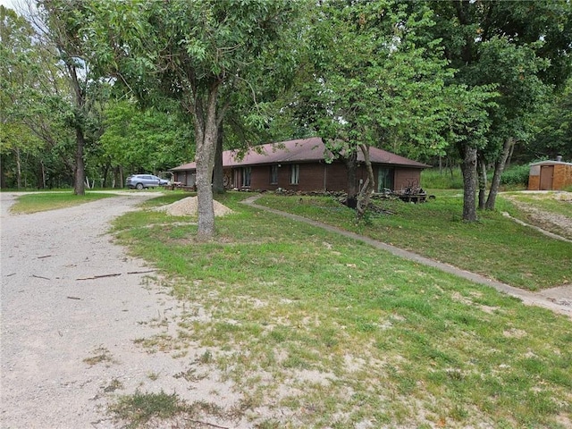 ranch-style home featuring a front yard