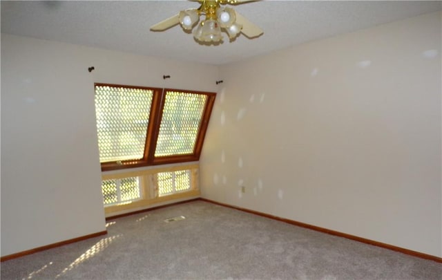 empty room featuring carpet flooring and ceiling fan