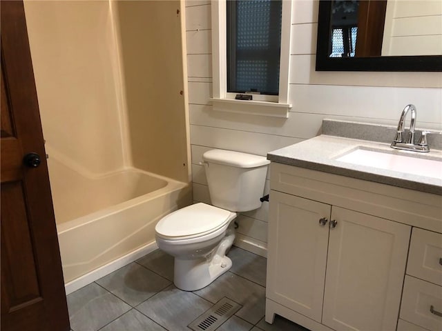 full bathroom with tile patterned flooring, vanity, toilet, and washtub / shower combination