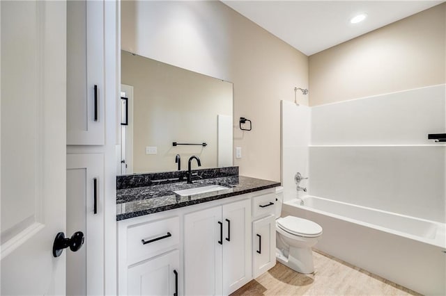 full bathroom with toilet, vanity, and bathtub / shower combination