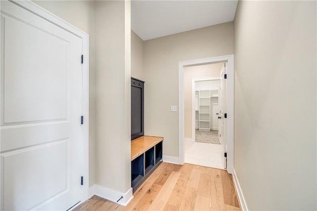mudroom with baseboards and light wood-style floors