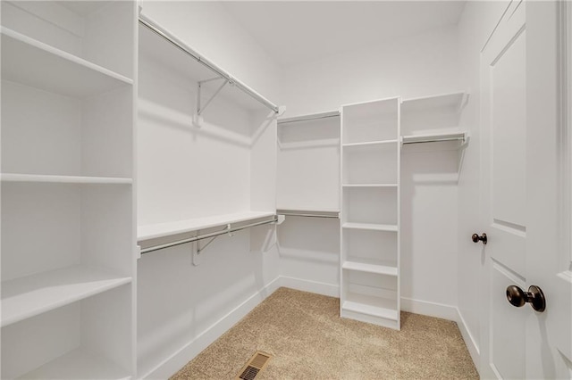 walk in closet featuring visible vents and carpet