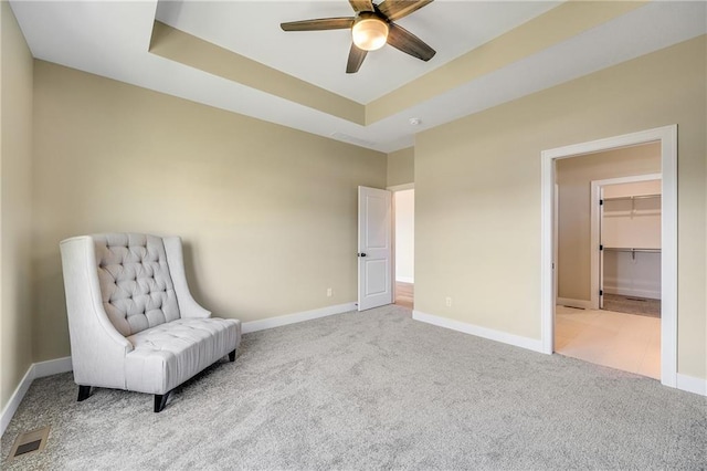 sitting room with visible vents, baseboards, carpet flooring, and ceiling fan