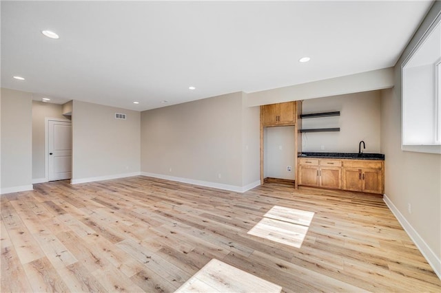 unfurnished living room featuring recessed lighting, visible vents, light wood finished floors, and baseboards