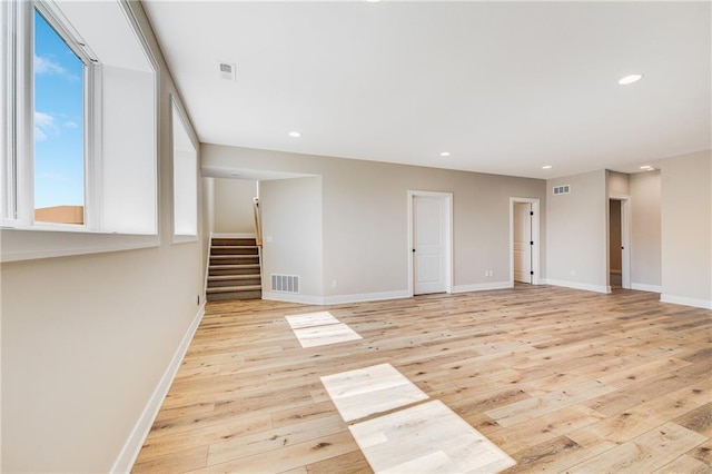 interior space with recessed lighting, stairway, visible vents, light wood-type flooring, and baseboards