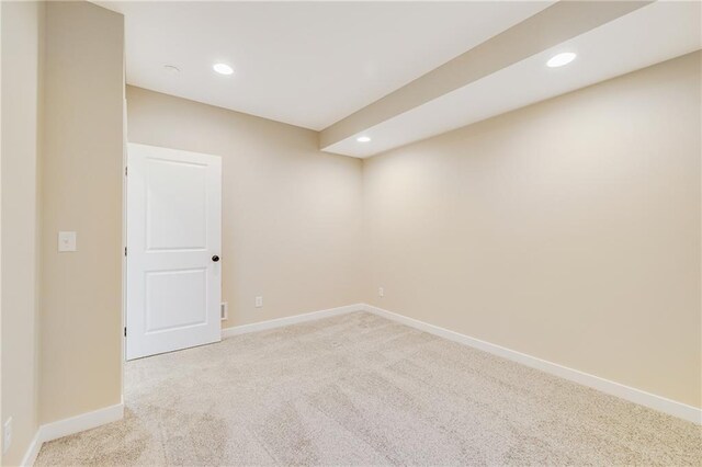 finished basement featuring baseboards, recessed lighting, and light colored carpet