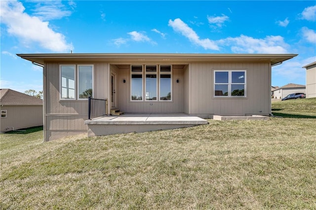 rear view of property featuring a lawn