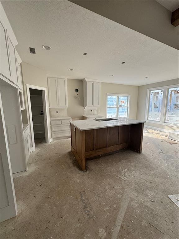 kitchen featuring a large island and white cabinets