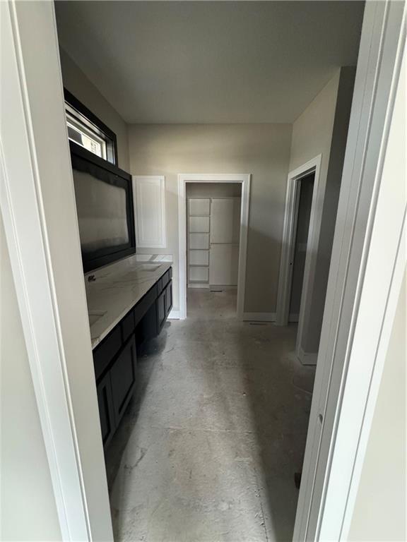 bathroom with vanity and concrete flooring