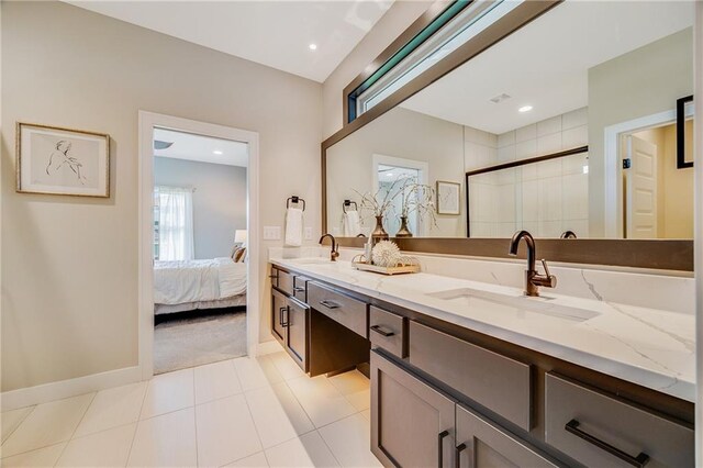 ensuite bathroom featuring ensuite bath, a sink, a shower stall, and double vanity
