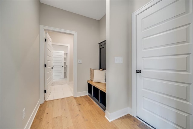 mudroom with light wood finished floors and baseboards