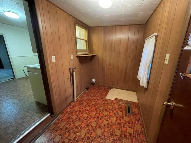 washroom featuring wooden walls