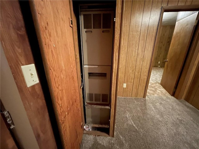 corridor with carpet flooring and wooden walls