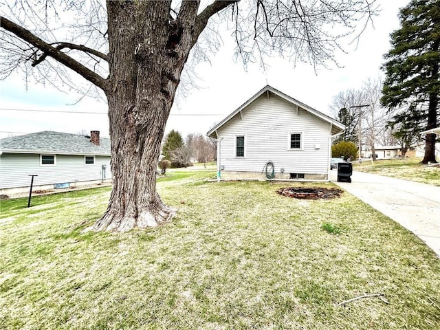 view of property exterior featuring a lawn