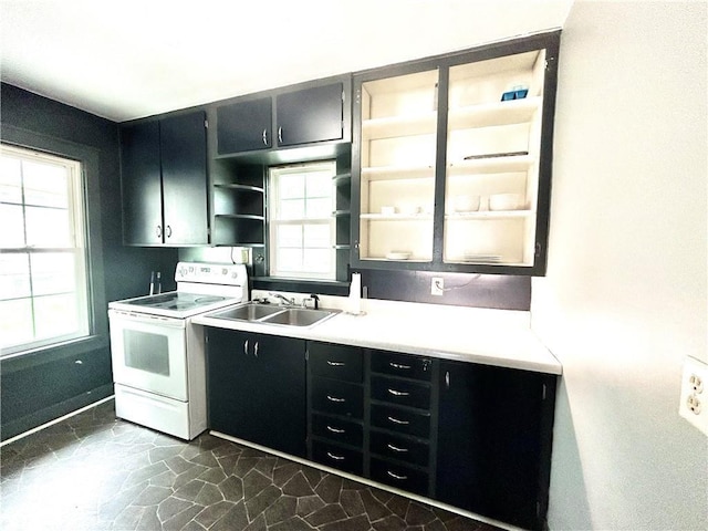 kitchen featuring sink, electric range, and a healthy amount of sunlight