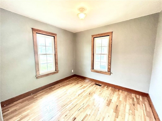 spare room featuring light hardwood / wood-style floors