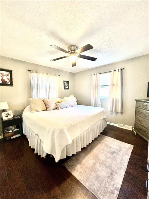 bedroom with a textured ceiling and ceiling fan