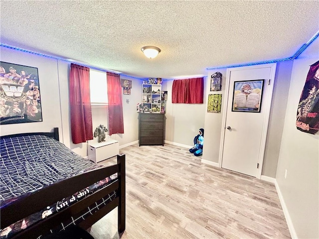 bedroom featuring hardwood / wood-style floors and a textured ceiling