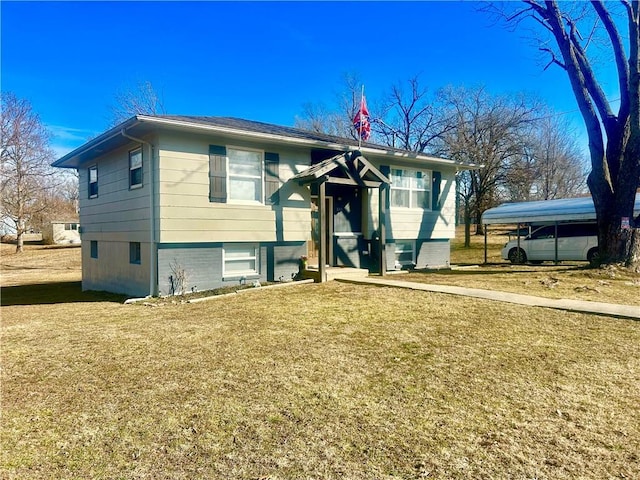 raised ranch featuring a front yard and a carport