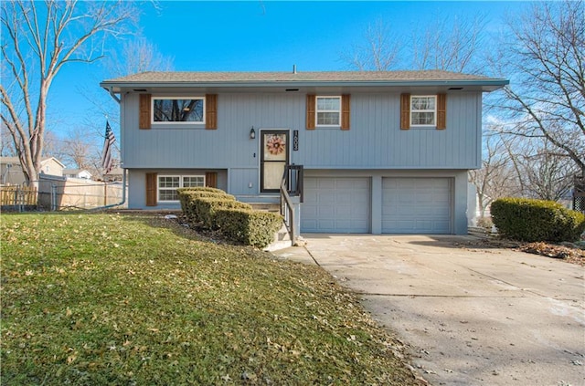 split foyer home featuring a garage and a front lawn