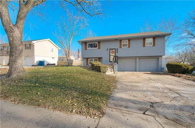 raised ranch with a garage and a front yard