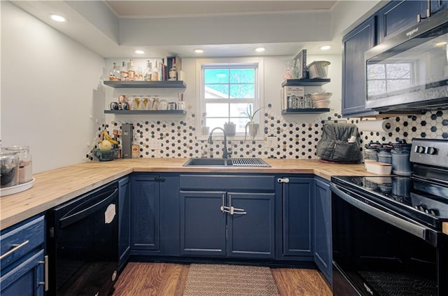 kitchen with blue cabinetry, wood counters, sink, dark hardwood / wood-style flooring, and black appliances