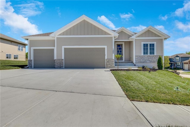 view of front of home featuring driveway, stone siding, board and batten siding, and a garage