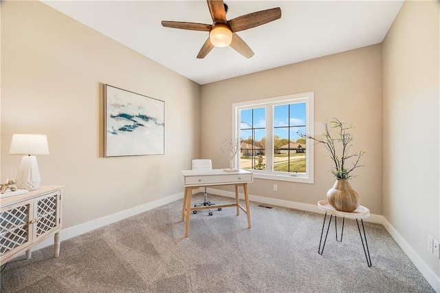 office space with baseboards, a ceiling fan, carpet flooring, and visible vents