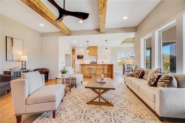 living area with recessed lighting, beam ceiling, and light wood-style flooring