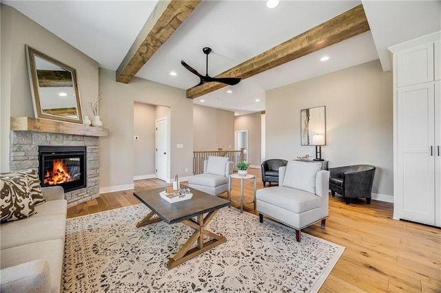living area with light wood-style flooring, beam ceiling, baseboards, recessed lighting, and a ceiling fan