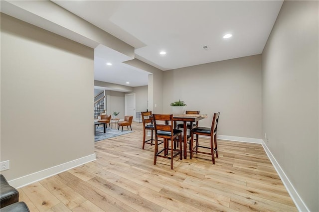 dining space with baseboards, recessed lighting, light wood-style floors, visible vents, and stairs