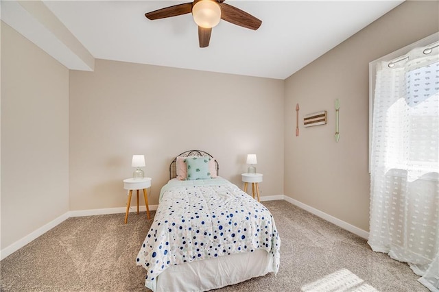 bedroom with ceiling fan, baseboards, and carpet