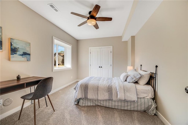 carpeted bedroom featuring baseboards, a ceiling fan, visible vents, and a closet