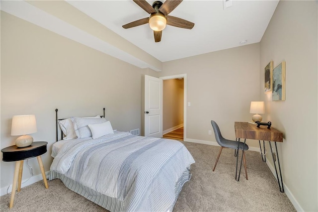bedroom featuring baseboards, visible vents, a ceiling fan, and light colored carpet